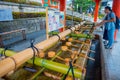 KYOTO, JAPAN - JULY 05, 2017: Unidentified people washing their hands at hand wash pavilion in Fushimi Inari Shrine in Royalty Free Stock Photo