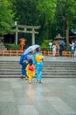 KYOTO, JAPAN - JULY 05, 2017: Young Japanese women wearing traditional Kimono and holding umbrellas in their hands in