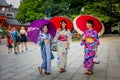KYOTO, JAPAN - JULY 05, 2017: Young Japanese women wearing traditional Kimono and holding umbrellas in their hands in