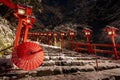 Kyoto, Japan. Kifune shrine in snowy winter night. Japanese umbrella on the stone stairs. Royalty Free Stock Photo