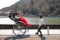 Chinese tourists boarded a rickshaw pulled by a young man