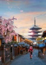 Y???asaka pagoda sunset in Kyoto with a young Japanese woman in a traditional Kimono dress Royalty Free Stock Photo