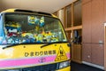 Kyoto, Japan, 07/11/19. Minions yellow school bus with lots of Mionions teddies and toys parked in front of the school in Kyoto