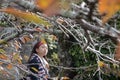 Young teenage enjoy the beauty of autumn leave at Philosopher`s Path in Kyoto, Japan