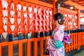 Asian women wearing japanese traditional kimono visiting the beautiful in Fushimi Inari Shrine in Kyoto, Japan Royalty Free Stock Photo