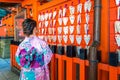 Asian women wearing japanese traditional kimono visiting the beautiful in Fushimi Inari Shrine in Kyoto, Japan Royalty Free Stock Photo