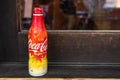 Coca-cola metal bottle, special edition 2018 with autumn maple leaves print pattern in red, yellow and orange colors, front side