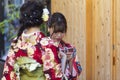 KYOTO, JAPAN - NOVEMBER, 8, 2019: Couple of  Young Japanese Girls Wearing Traditional Geisha`s Kimono Taking Photos On Kyoto Royalty Free Stock Photo