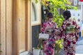 KYOTO, JAPAN - NOVEMBER, 8, 2019: Couple of  Young Japanese Girls Wearing Traditional Geisha`s Kimono Taking Photos On Kyoto Royalty Free Stock Photo