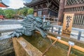 Dragon and Hishaku dippers of Chozuya or Temizuya water ablution pavilion at Kiyomizu-dera Buddhist Temple. Located in HIgashiyama