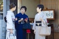 KYOTO, JAPAN - NOVEMBER, 8, 2019: Group of Mature Japanese Females Wearing Traditional Silk Geisha`s Kimono Traveling on Street o