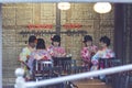 Group of Young Japanese Girls Wearing Traditional Geisha`s Kimono Dining At A Restaurant of Royalty Free Stock Photo