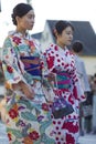 Group of Young Japanese Girls Wearing Traditional Silk Geisha`s Kimono Traveling on Street of Royalty Free Stock Photo