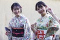 Group of Young Japanese Ladies in Geisha Silk Kimono Posing On One of the Kyoto Streets, Japan Royalty Free Stock Photo