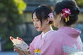 KYOTO, JAPAN - NOVEMBER, 8, 2019: Japanese Ladies Posing in Geisha Kimono At One of the Kyoto Streets, Japan Royalty Free Stock Photo