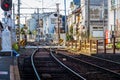 Japanese man riding bike to cross railroad tracks