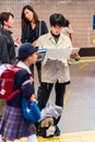 KYOTO, JAPAN - NOVEMBER 7, 2017: Japanese man on the subway reading a book. Copy space for text. Vertical.