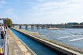 Kyoto, Japan - November 17, 2017 :Many tourists wallking on Togetsukyo bridge to cross Hozu-gawa river during autumn season in Ar