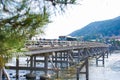 Kyoto, Japan - November 17, 2017 :Many tourists wallking on Togetsukyo bridge to cross Hozu-gawa river during autumn season in Ar