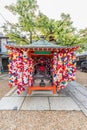 Kukurizaru round, ball shaped cloth talisman at Yasaka Koshindo, dedicated to Koshin-san or Shomen Kongo a blue, guardian warrior