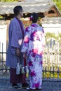 Young Lovely Couple in Geisha Silk Kimono Posing On One of the Kyoto Streets, Japan