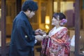 KYOTO, JAPAN - NOVEMBER, 8, 2019: Young Lovely Couple in Traditional Geisha Kimono Posing With Dango Moti Balls in Kyoto, Japan