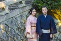 KYOTO, JAPAN - NOVEMBER, 8, 2019: Young Man and Woman Wearing Traditional Japanese Kimono Posing in Kyoto, Japan