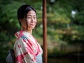 Kyoto, Japan - October 03: Unidentified female tourist in tradional Japanese clothes smiles in Shoren-In temple on Royalty Free Stock Photo