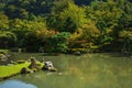 Colored autumn trees along pond at traditional Japanese zen garden Sogenchi at Tenryu-ji Temple in Kyoto, Japan Royalty Free Stock Photo