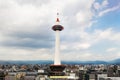 Kyoto Tower seen against a cloudy sky