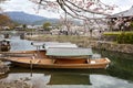 Kyoto, Japan, 04/06/2017: Traditional wooden Japanese boats on the river in a beautiful flowering spring nature. Holiday Hanami Royalty Free Stock Photo