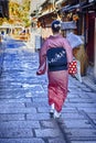 Kyoto Traveling. Geisha in Traditional Japanese Kimono and Rucksack Posing on Famous Gion Street in Kyoto City, Japan