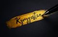 Kyrgyzstan Handwriting Text on Golden Paint Brush Stroke