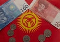 Kyrgyzstan kyrgyz flag banknotes coins red yellow background Royalty Free Stock Photo