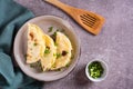 Kystyby - a thin flatbread filled with mashed potatoes and onions on a plate on the table. Top view