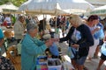 tourists of various nationalities shop in the characteristic market of typical products in Potamos, Greece