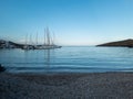 Kythnos island, Cyclades Greece. Loutra village empty beach, sailboats and yachts moored