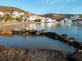 Kythnos island Cyclades Greece. Loutra village, traditional white buildings shops sandy empty beach