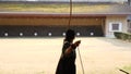 Kyudo practicing bow shooting slowmotion in Kyoto, Japan.