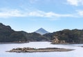 A japanese oyster farmer wearing a chest waders walking on an islet of Kujukushima islands in Sasebo.