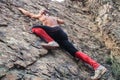 Kyzyl, Tuva - August 15, 2015: Young attractive sexy strong male athlete rock climber climbs