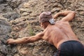 Kyzyl, Tuva - August 15, 2015: Young attractive sexy strong male athlete rock climber climbs on a rock. Strong muscular male