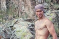 Kyzyl, Tuva - August 15, 2015: Young attractive sexy strong male athlete rock climber climbs on a rock. Strong muscular male