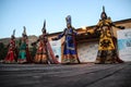 Mongolian woman in shaman and witch costume dances on stage in the mountains. Tyva folk dances