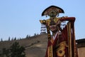 Mongolian woman in shaman and witch costume dances on stage in the mountains. Tyva folk dances