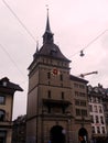 KÃÂ¤figturm, a 17th-century Baroque tower with a clock and bell at dusk, Bern, Switzerland.