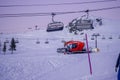 L`Alpe D`Huez, France 30.12.2019 Later evening. Cableway lift cabin background. A special machine prepares the ski slope