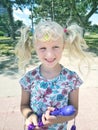 l funny Caucasian blonde girl with pigtails and butterfly on her hair. Royalty Free Stock Photo