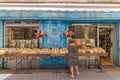 Woman at a small book shop in L`Isle-sur-la-Sorgue