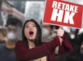 L pacifist Asian woman angry and outraged protesting on street demonstration against China abuse standing for freedom and human